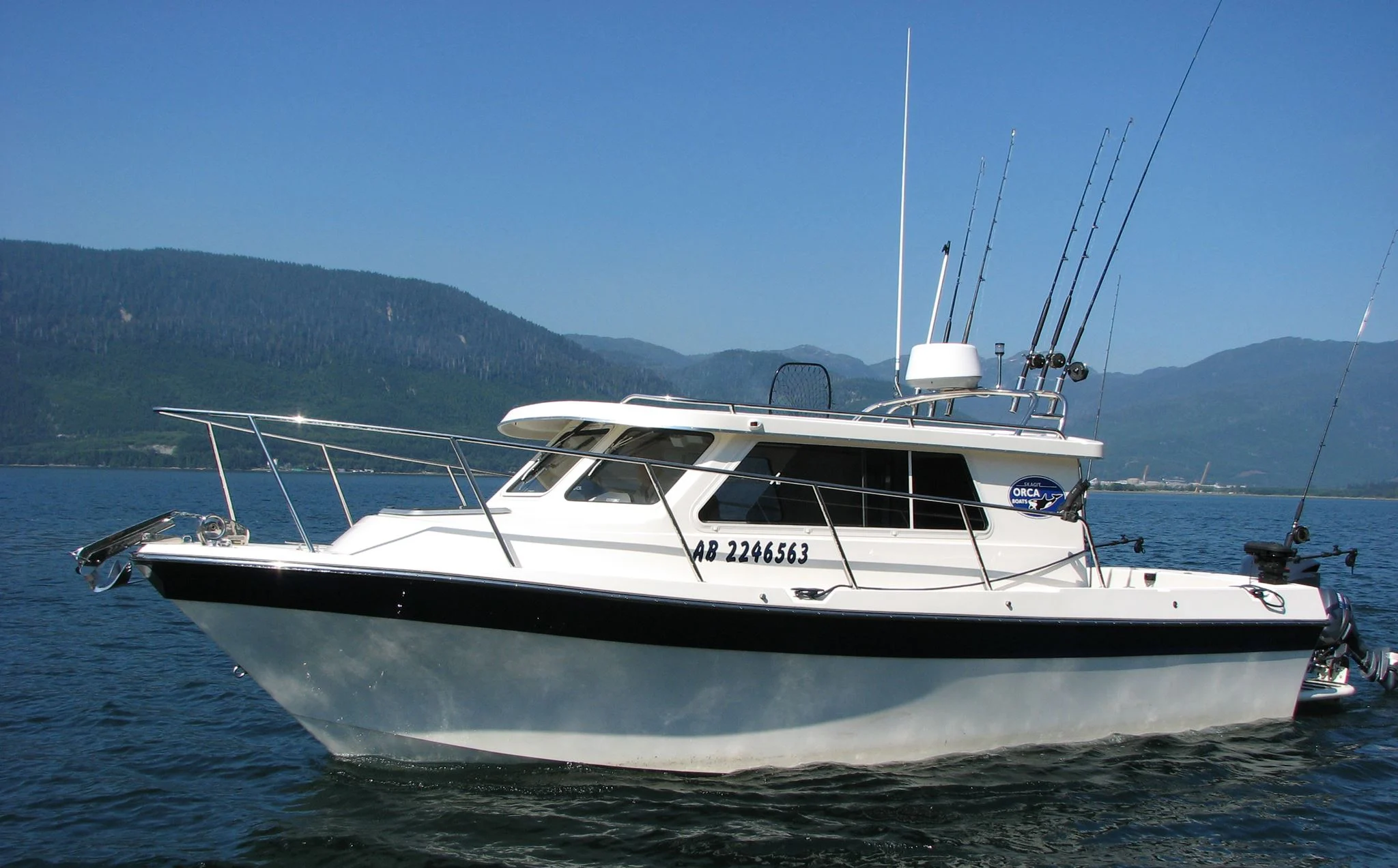24-foot KLC fishing boat “Blue Heron” cruising on the Douglas Channel, equipped for halibut, salmon, and sightseeing tours.