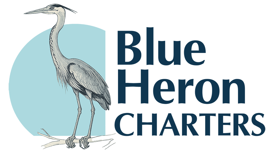 Blue Heron Charters fishing boat on the Douglas Channel in Kitimat, BC, shown under the company logo promoting guided fishing and coastal tourism.